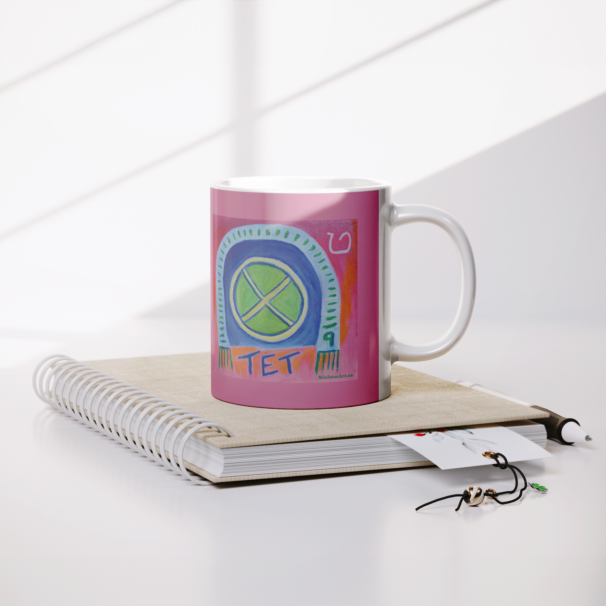 TET_White_Mug_with_Pink_Background___Lifestyle_Notebook_Mockup.png